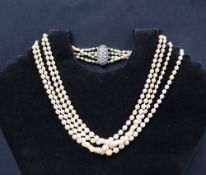 A four strand graduated pearl necklace to a white metal marcasite set clasp,