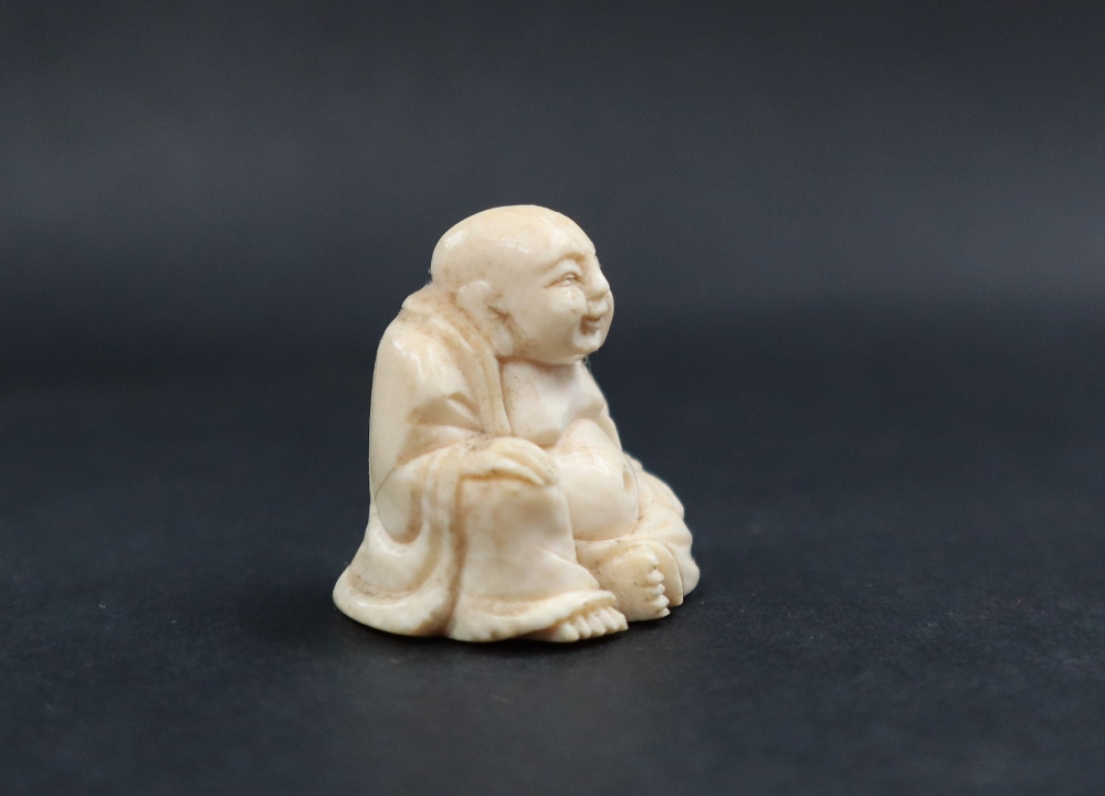 A late 19th / early 20th century ivory figure of Hotei, seated with his right hand on his knee, - Image 9 of 9