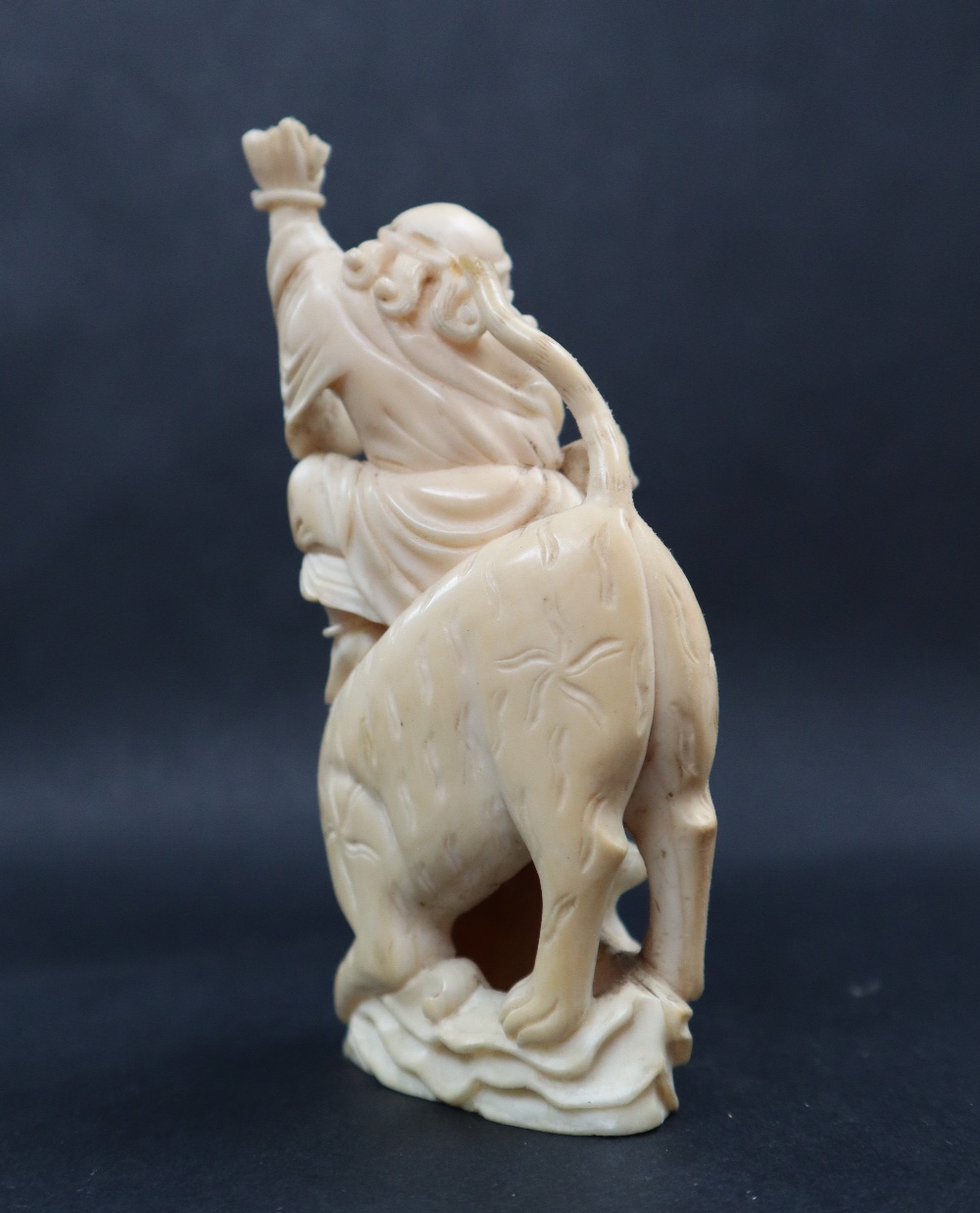 A simulated ivory figure group of a figure riding a tiger, 11cm high, - Image 5 of 7