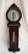 A Joseph Davis American Forecast barometer, with a pierced cresting rail above a silvered dial,