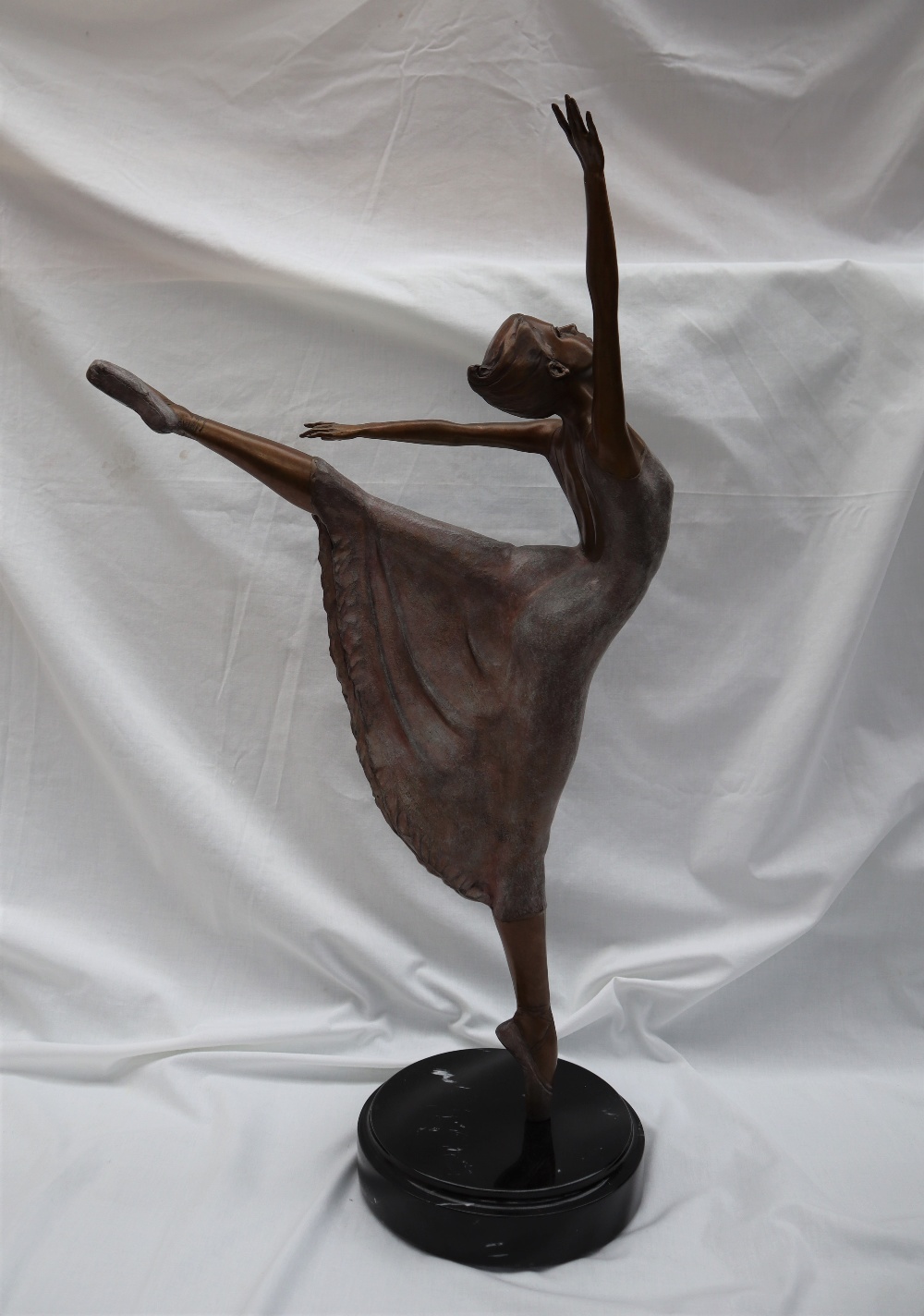 Mario Jason Estrella A ballerina on point with arms raised Bronze with silvered decoration On a