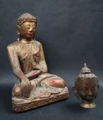 A carved and gilt decorated figure of a seated Buddha,