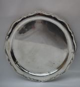 A silver tray of circular form,. with a wave rim, marks indistinct, 31.