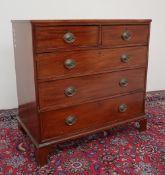 A George III mahogany chest of drawers with two short and three long drawers on bracket feet,