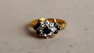 An 18ct yellow gold sapphire and diamond cluster ring,