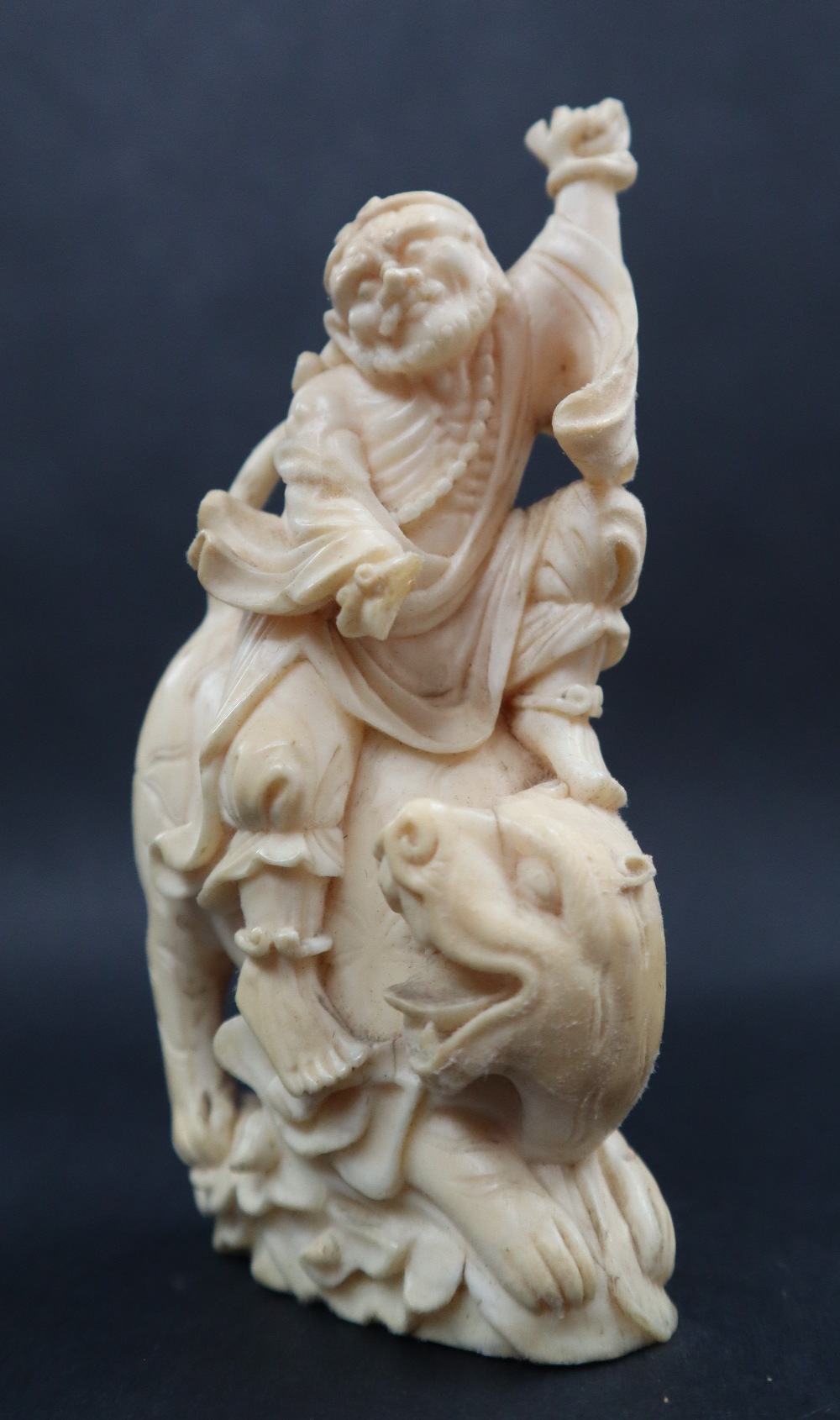 A simulated ivory figure group of a figure riding a tiger, 11cm high, - Image 3 of 7