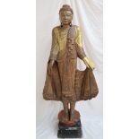A carved and gilt decorated buddhistic figure,