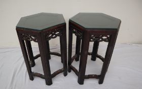 A pair of Chinese hardwood hexagonal topped occasional tables with a pierced apron on tapering legs