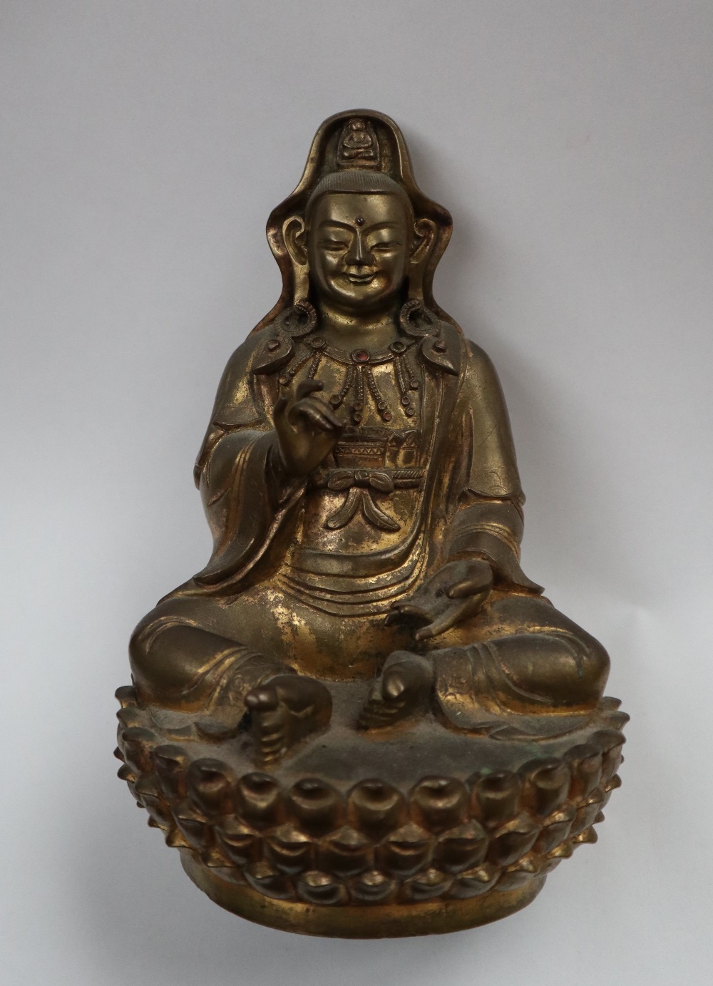 A Bronze figure of Quan yin, seated with right hand raised and left hand resting on her leg, - Image 2 of 9