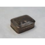 A continental silver pill box of rectangular form, decorated with scrolls and leaves, 35mm x 25mm,