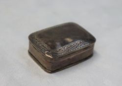 A continental silver pill box of rectangular form, decorated with scrolls and leaves, 35mm x 25mm,