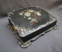 A Victorian papier mache writing slope, inlaid with mother of pearl and gilt decorated leaves,