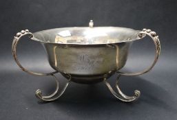 An Edward VII silver three handled bowl, of tapering circular form, with scrolling feet,