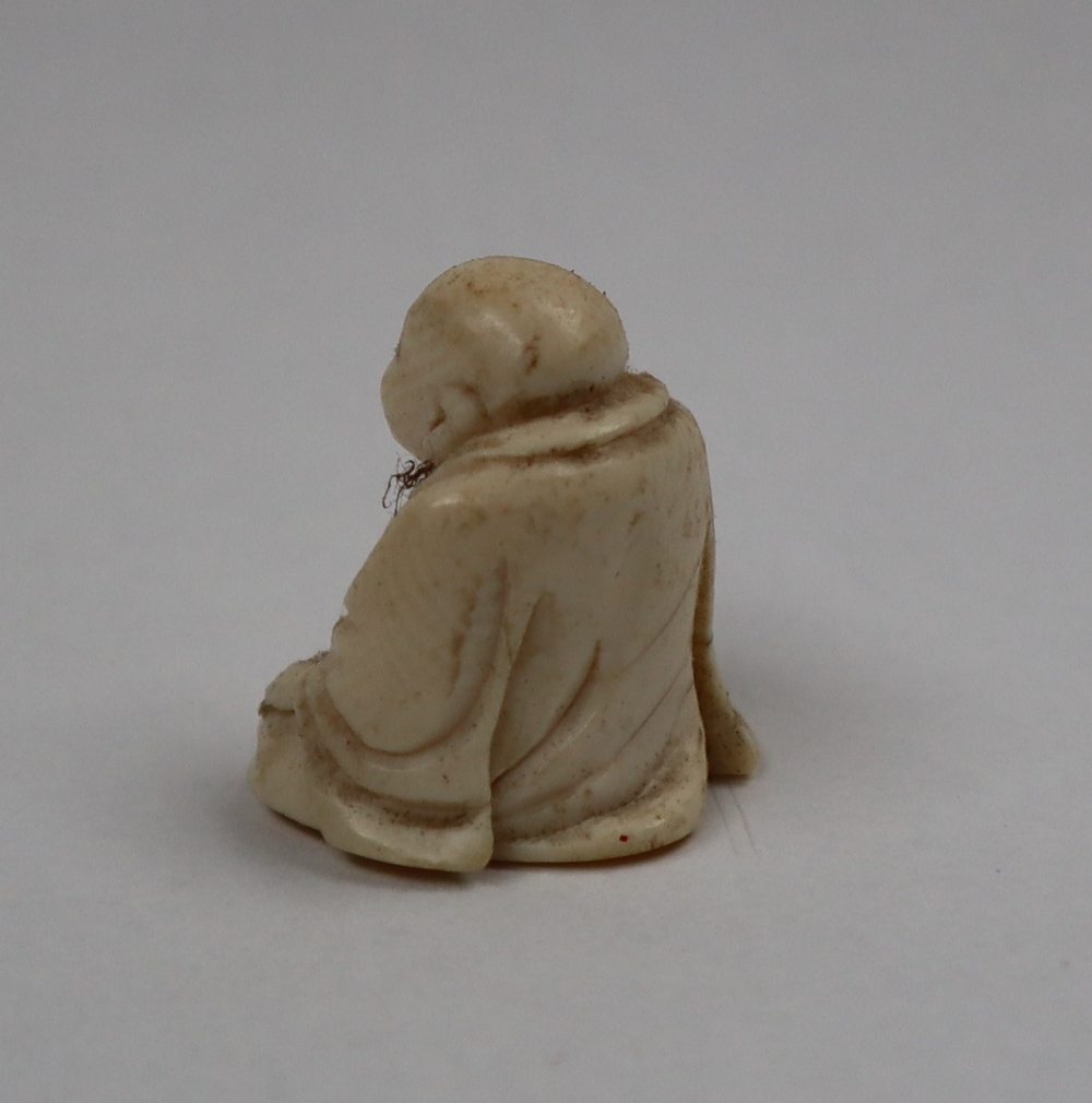 A late 19th / early 20th century ivory figure of Hotei, seated with his right hand on his knee, - Image 3 of 9