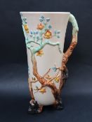 A Clarice Cliff Newport pottery moulded jug, decorated with tree branches, flowerheads and leaves,