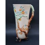 A Clarice Cliff Newport pottery moulded jug, decorated with tree branches, flowerheads and leaves,