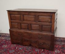 An 18th century oak mule chest, the rectangular planked top above a panelled front ,