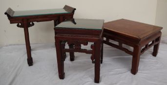 A Chinese hardwood altar table of rectangular form, with raised scrolling top on four splayed legs,