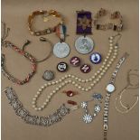 Assorted costume jewellery including faux pearls, commemorative medals, enamel pin badges,