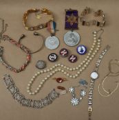 Assorted costume jewellery including faux pearls, commemorative medals, enamel pin badges,