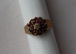 A 9ct yellow gold ruby and diamond cluster ring, set with twelve rubies and seven diamonds,