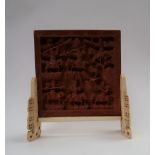 A 19th century Chinese table top screen, the square panel carved with warriors,