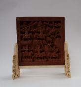 A 19th century Chinese table top screen, the square panel carved with warriors,