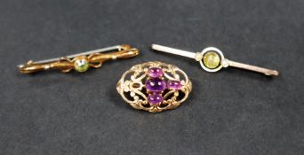 A 9ct yellow gold brooch set with four cabochon amethysts together with a 9ct gold citrine and