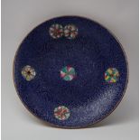 A Chinese porcelain dish, with an incised blue ground, inset with polychrome enamel roundels, 15.