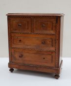 A 19th century walnut miniature chest,