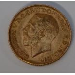 A George V gold sovereign,