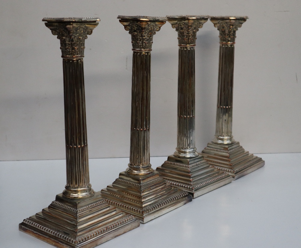 A set of four electroplated on copper Corinthian column candlesticks with stop fluted columns on a - Image 2 of 4