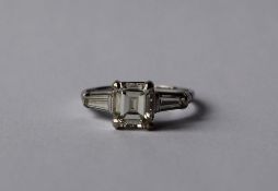 A diamond ring, the central emerald cut diamond approximately 1.