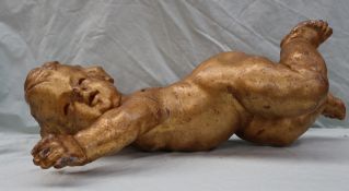 An 18th century gilt gesso cherub, with arms outstretched,