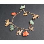 A Chinese yellow metal charm bracelet set with zodiac and other animals including a jade sheep's