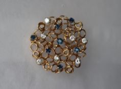 A 9ct yellow gold diamond and sapphire brooch,