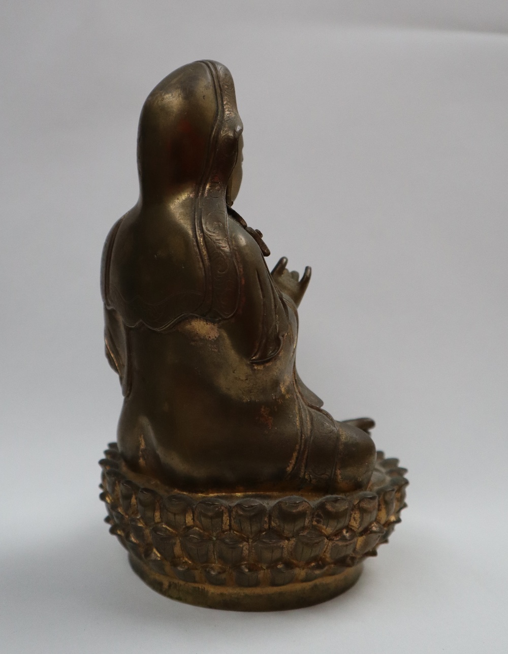 A Bronze figure of Quan yin, seated with right hand raised and left hand resting on her leg, - Image 5 of 9