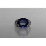 A sapphire and diamond ring, the oval faceted sapphire 14mm x 7mm,