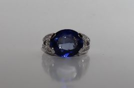 A sapphire and diamond ring, the oval faceted sapphire 14mm x 7mm,