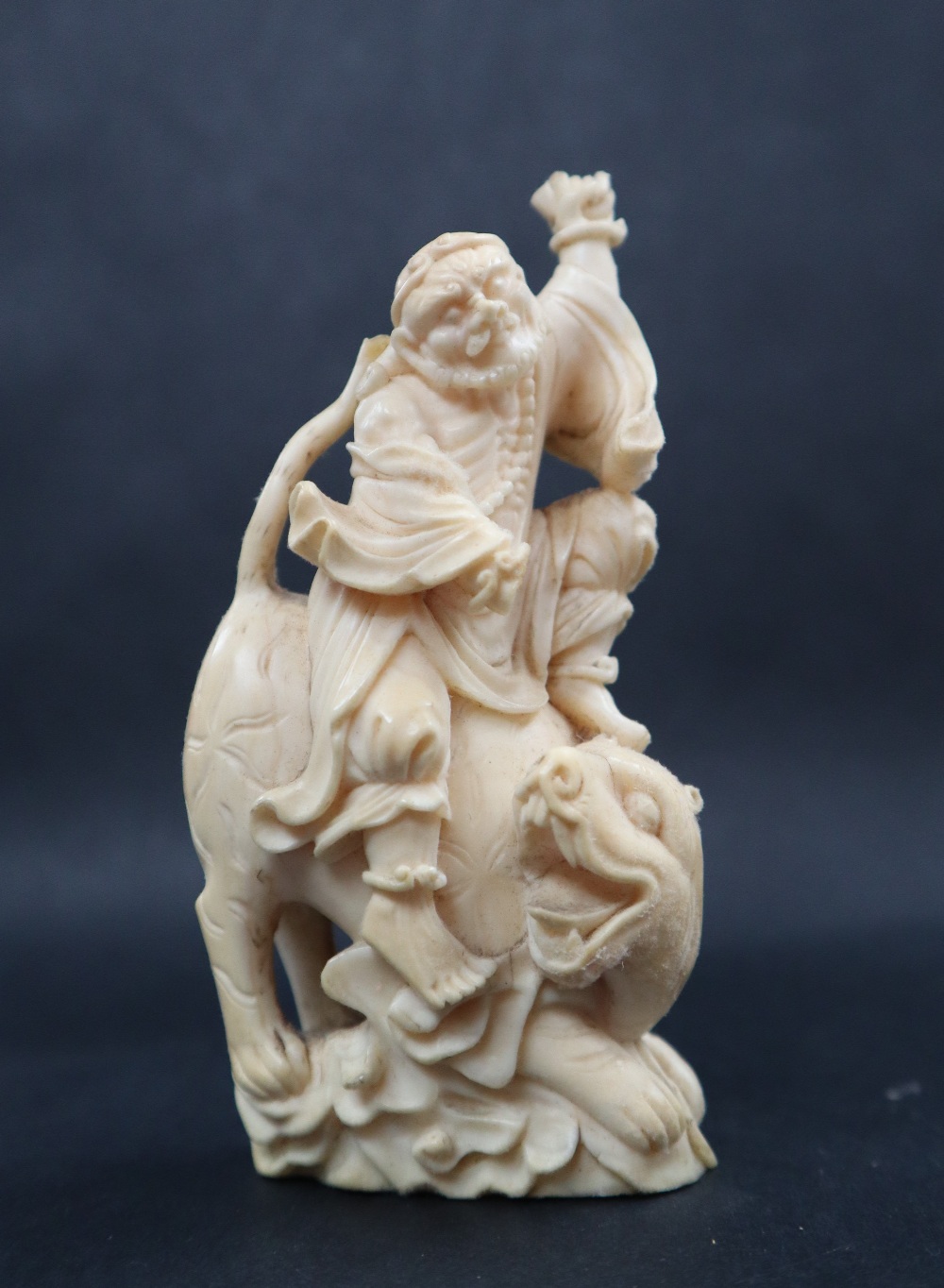 A simulated ivory figure group of a figure riding a tiger, 11cm high, - Image 2 of 7