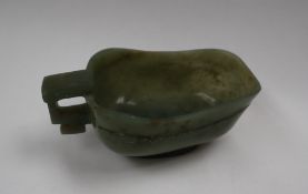 A Chinese spinach jade jug, of archaic form,