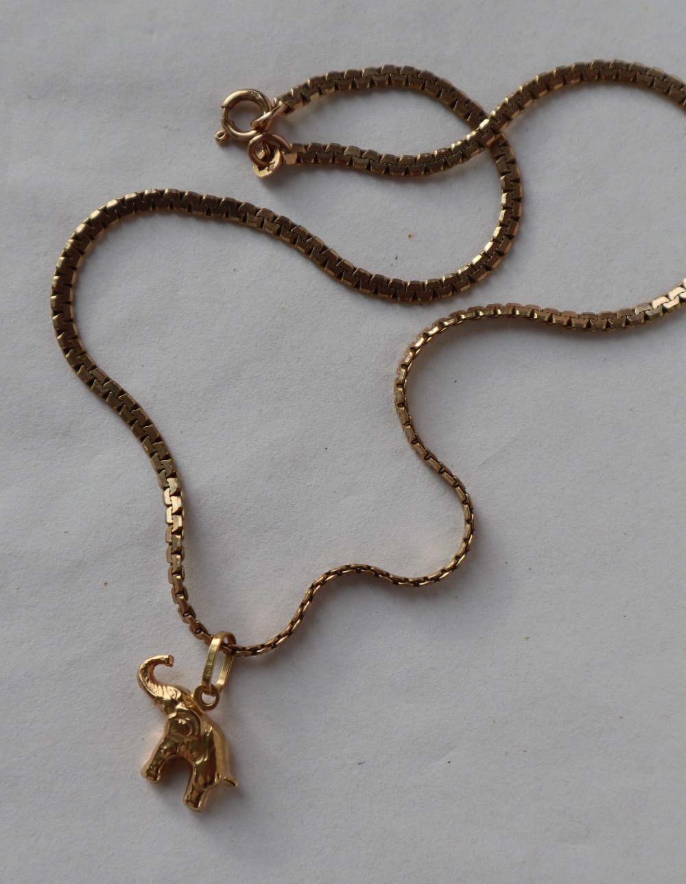 A 9ct yellow gold flat weave necklace, 39cm long together with an elephant pendant approximately 8. - Image 2 of 2