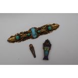 An Egyptian yellow metal bar brooch set with hardstones together with a Tutankhamun enamel