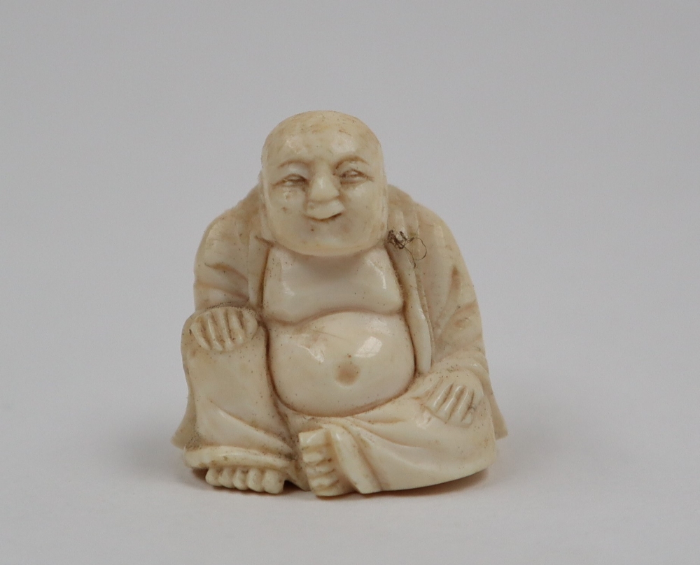 A late 19th / early 20th century ivory figure of Hotei, seated with his right hand on his knee, - Image 8 of 9