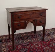 An 18th century oak lowboy,