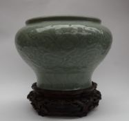 A Chinese celadon porcelain vase of squat inverted baluster form,
