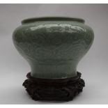 A Chinese celadon porcelain vase of squat inverted baluster form,
