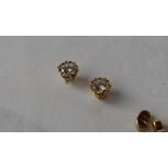 A pair of diamond stud earrings, the round brilliant cut diamonds each approximately 0.