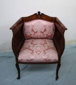 An Edwardian mahogany elbow chair, with a carved,