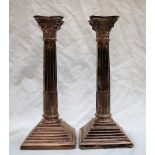 A pair of Elizabeth II silver Corinthian column candlesticks,